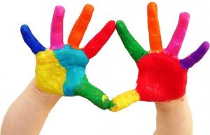 child's hands covered in paint